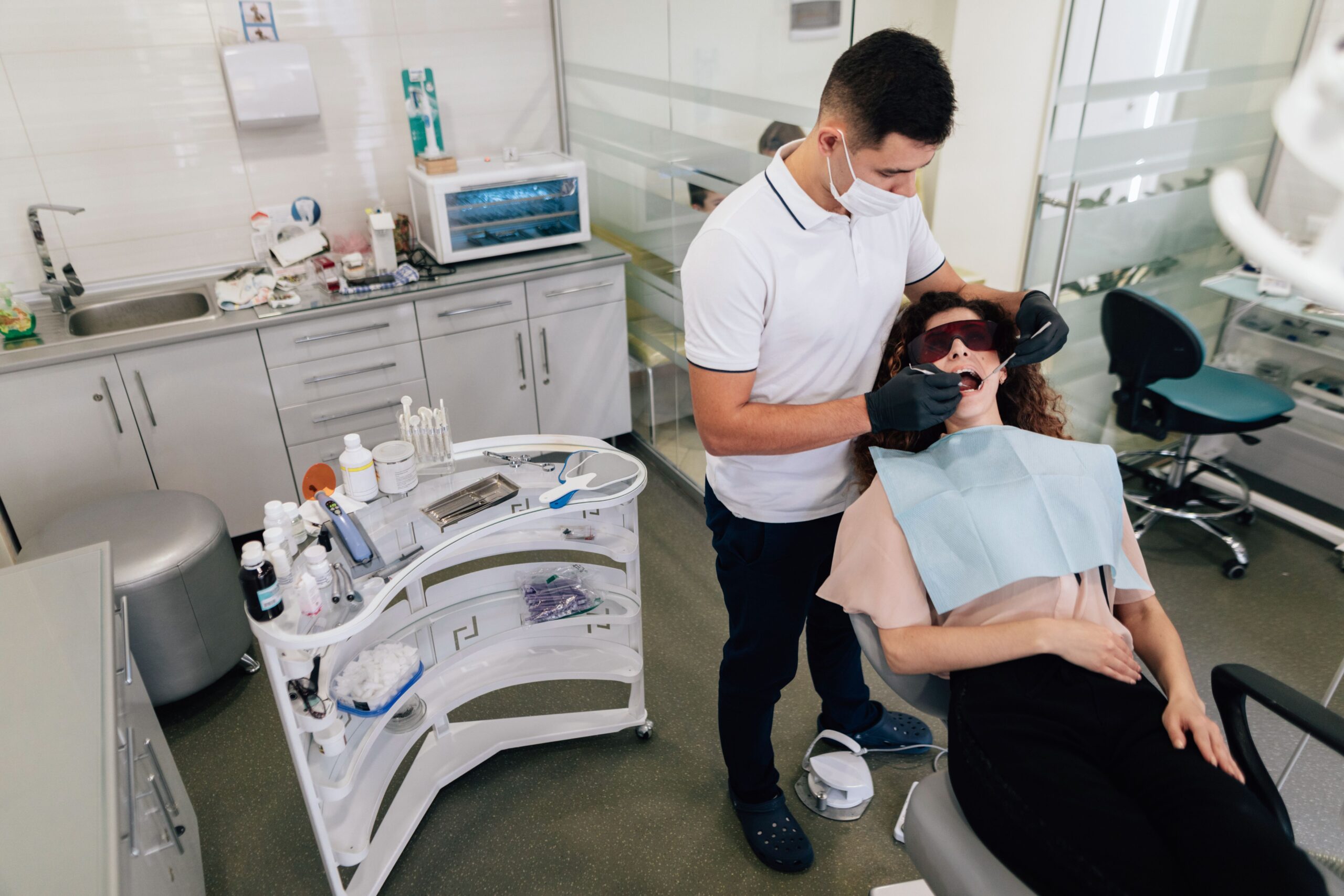 Family dentist in Boston examining a patient's teeth during a dental checkup