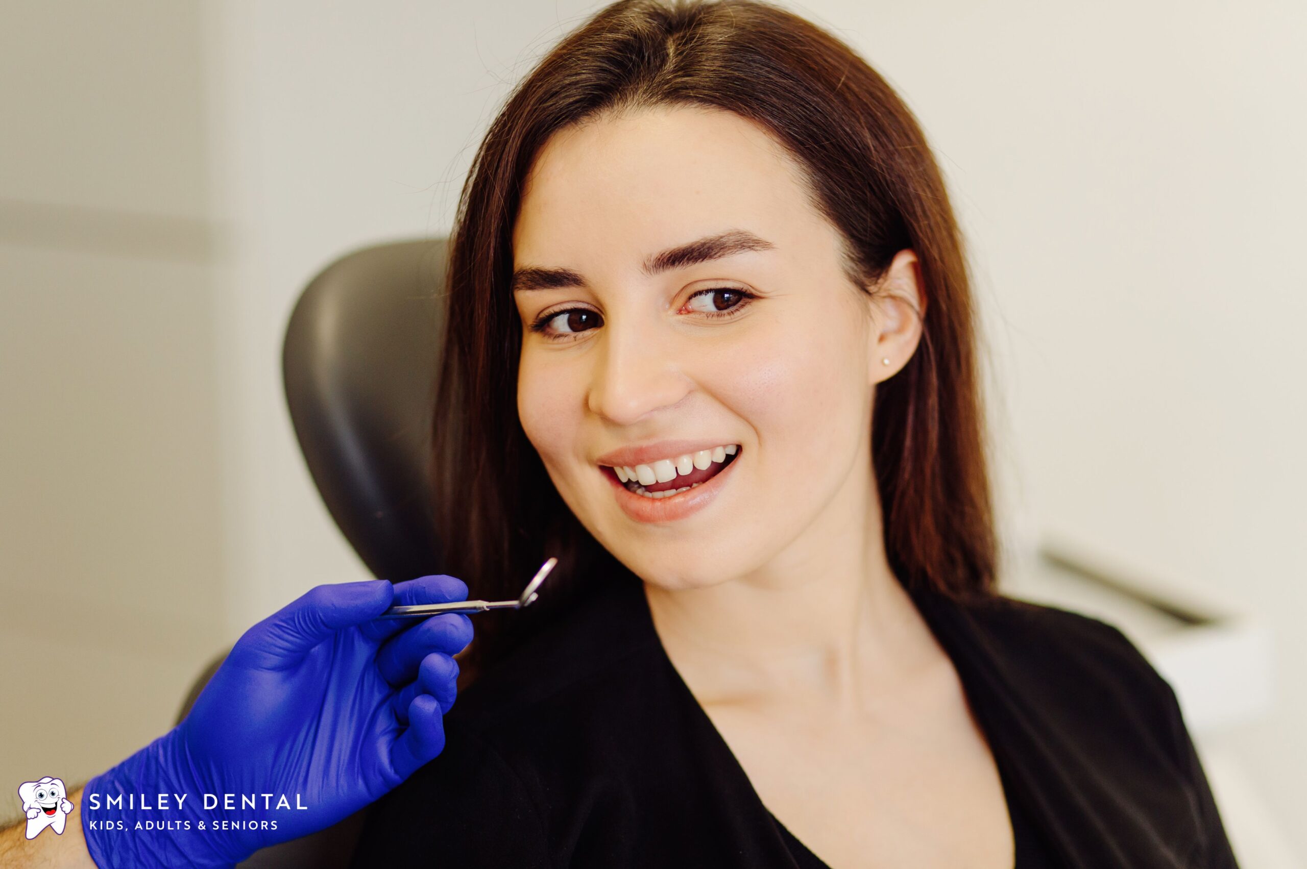Cosmetic dentist in Boston examining a patient's smile for veneers
