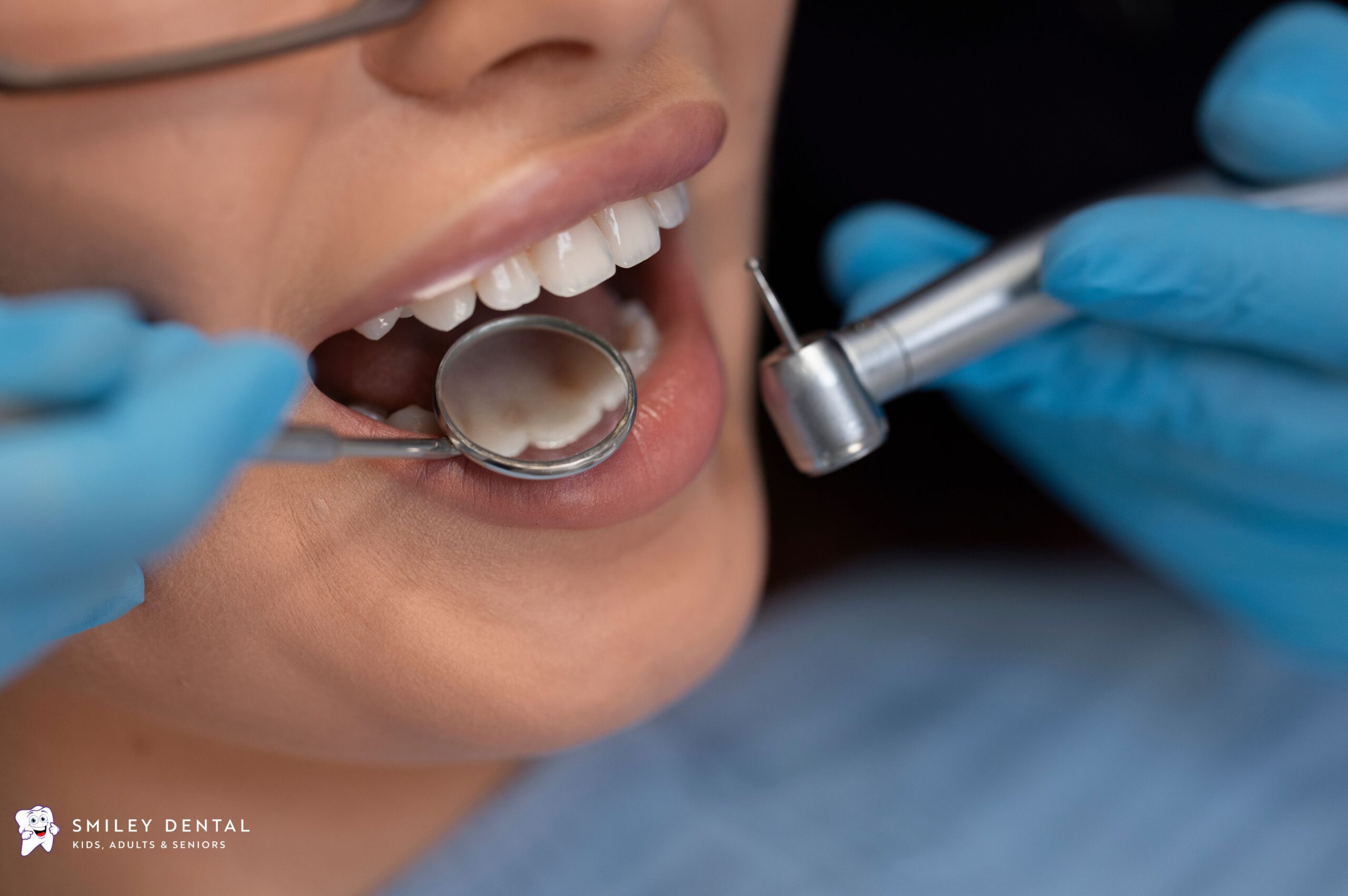 Dentist examining a patient’s teeth with professional dental instruments