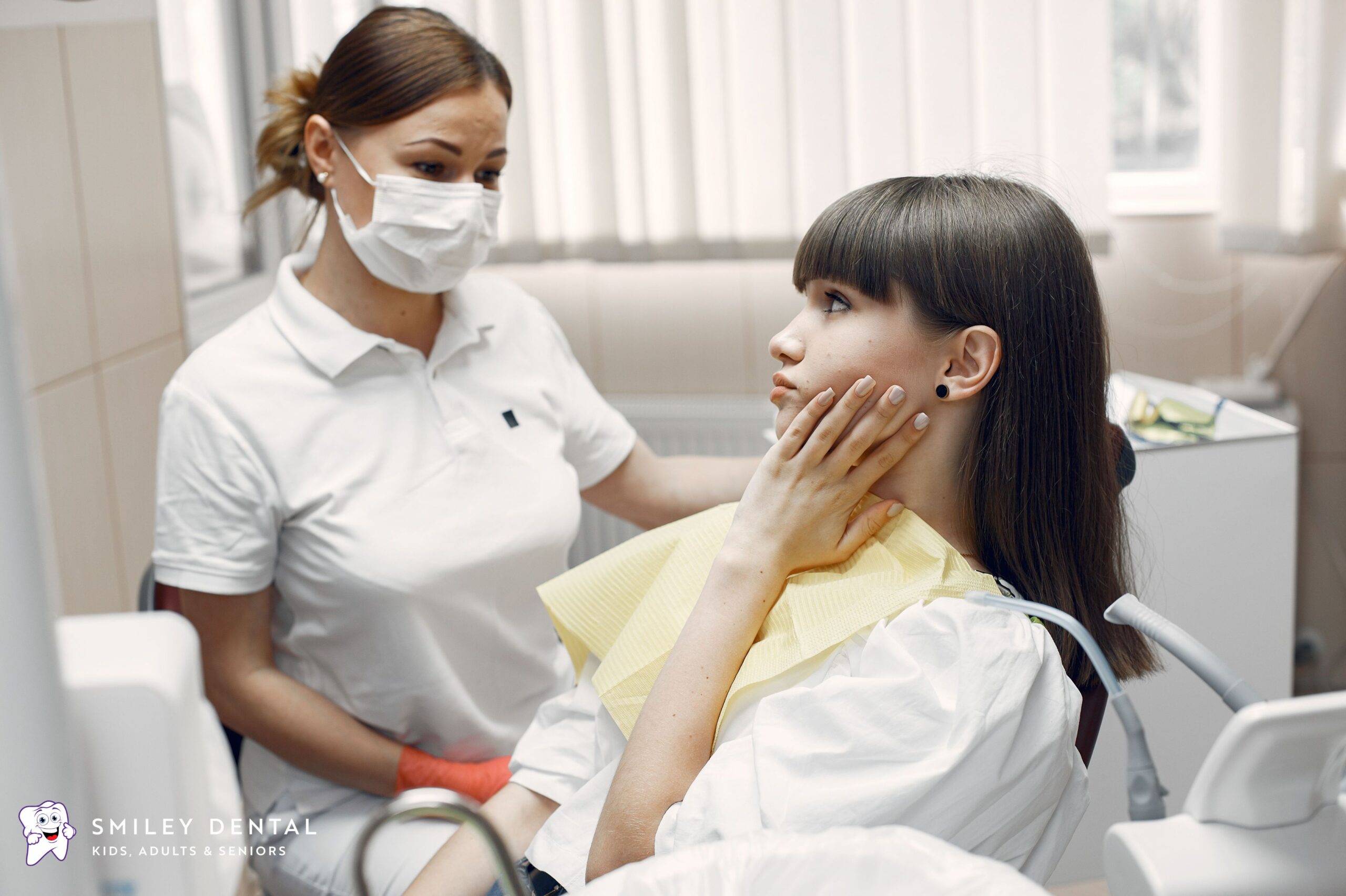 Patient discussing dental pain with dentist in Boston