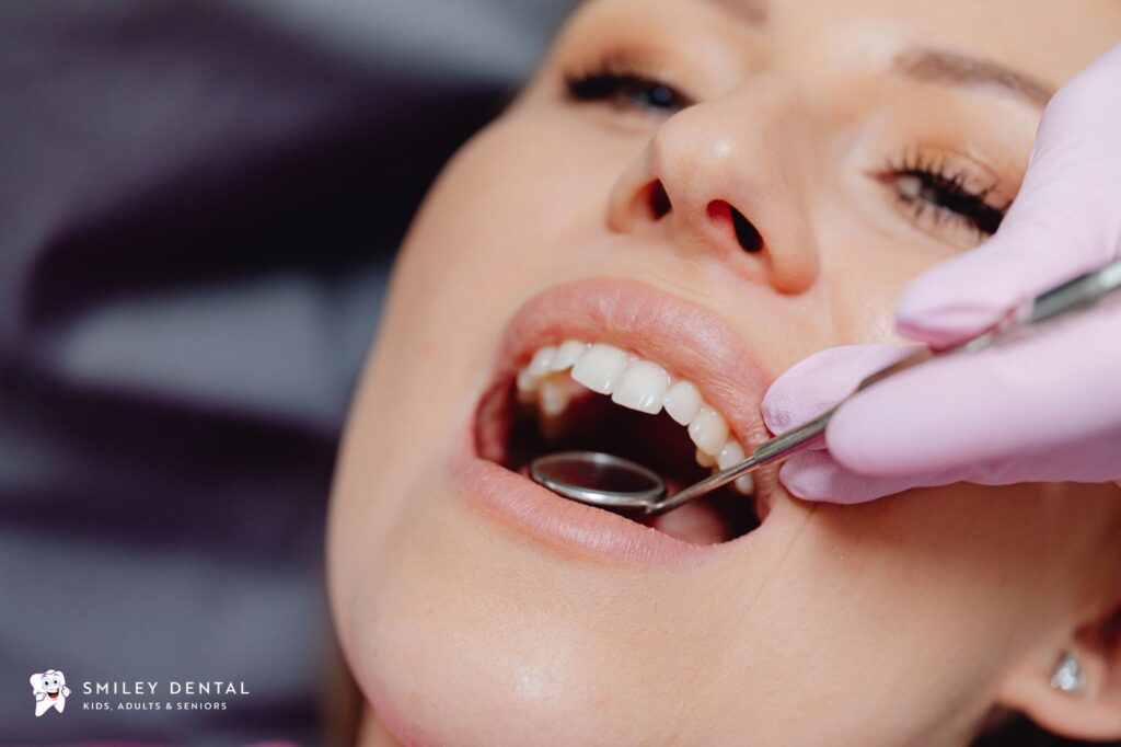 Dentist examining a patient's gums for signs of bleeding and inflammation