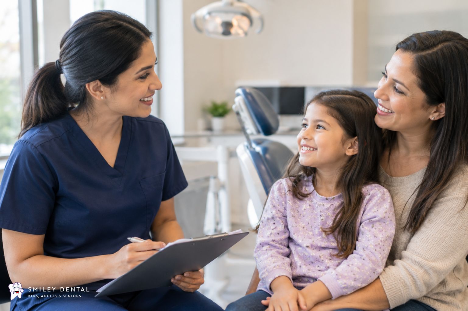 Dentist discussing a treatment plan with a mother and her young daughter in a dental office