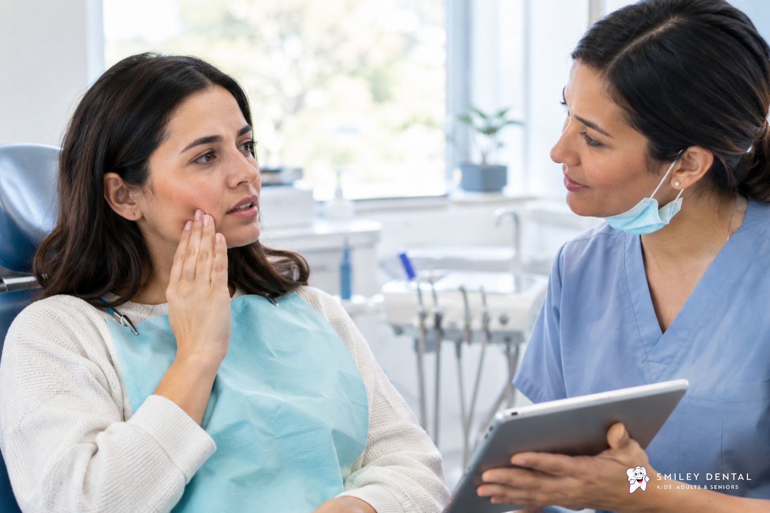 Dentist discussing cold tooth sensitivity with an adult patient